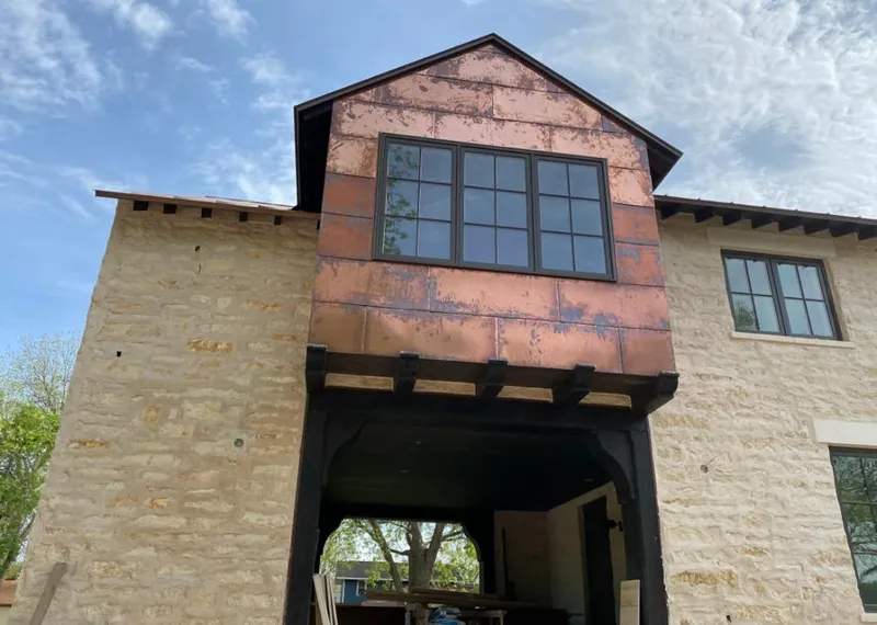 Copper metal panel facade on a stone building for Metal Roof Coating in Denver