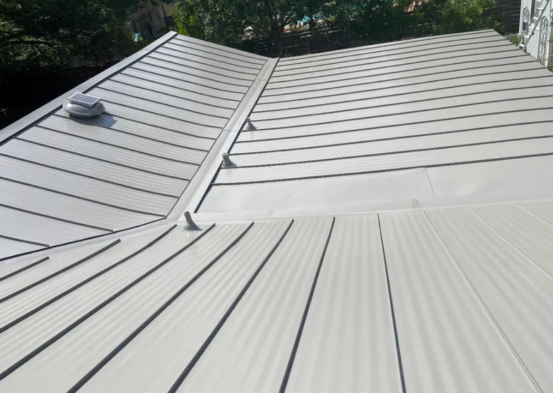Solar attic fan installed on a metal roof for Roof Ventilation in Denver